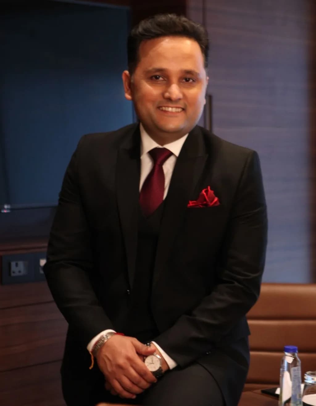 Amish Tripathi seated, smiling, in a dark suit
