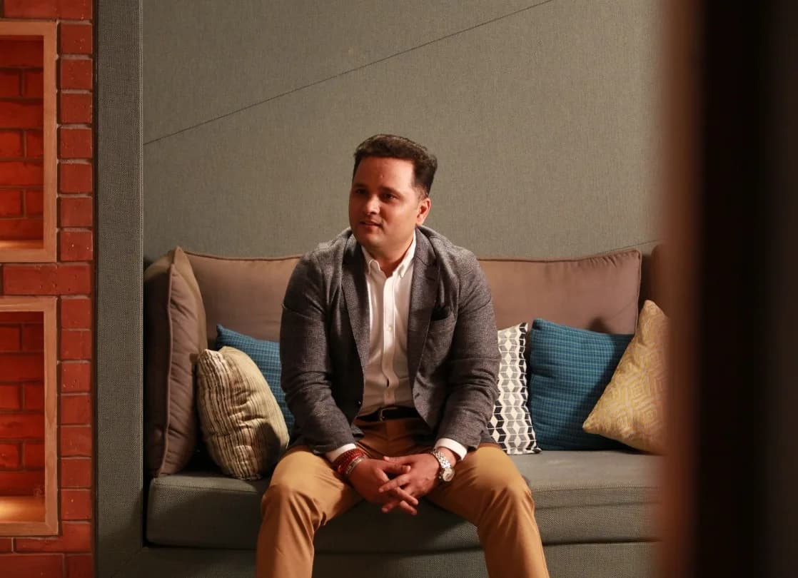 Amish Tripathi seated, looking to camera