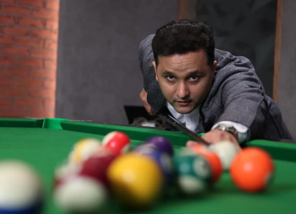 Amish Tripathi at a billiards table