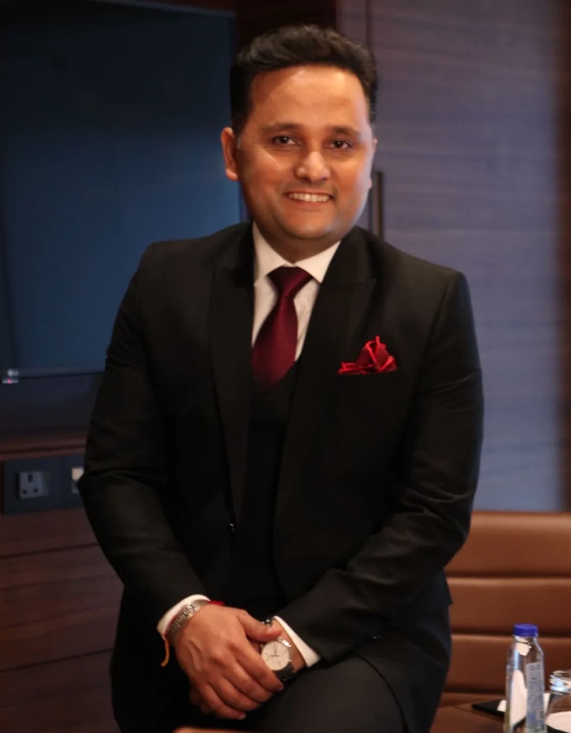 Amish Tripathi seated, smiling, in a dark suit