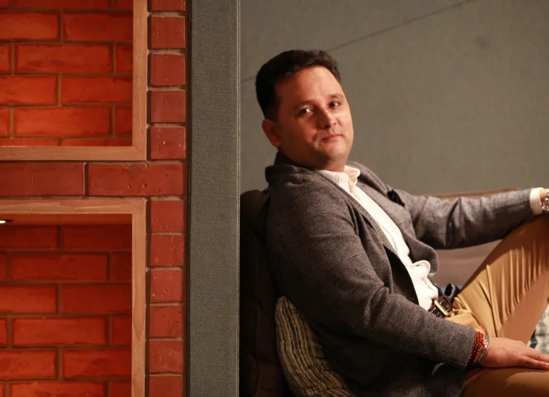 Amish Tripathi seated on a sofa in an interview setting